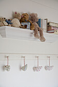Detail of a shelf with soft toys on it