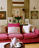 Cushions on pink sofa in traditional style sitting room