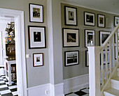 Collection of black and white pictures displayed in hallway