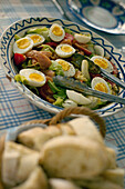 Salad nicoise of boiled egg anchovy tuna and lettuce