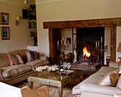 A traditional sitting room with a large open fireplace