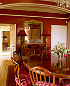 Red dining room with polished wooden table