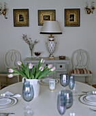 Traditional Swedish style dining room detail with white wood table and chairs