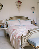 Antique double bed with floral pattern cover