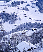 View from above of snow covered Swiss chalet in mountains