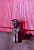 Close up of sculpted iron window catch on shutter of Swiss chalet