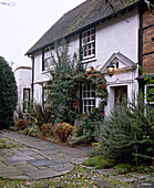 Exterior of detached whitewashed cottage