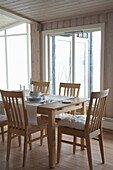 Contemporary wooden table and chairs in country style dining room