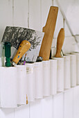 Close up of a number of tools in a painted holder