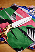Fabric samples and scissors in work studio of upholsterer