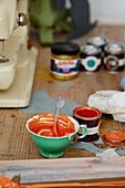 Teacup with paint in studio of printmaker