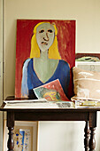 Art canvas and cushion on table in Cotswold studio of textile designer, UK