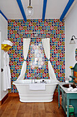 Brightly tiled bathroom with shower curtain and bathrobes Lot et Garonne, France