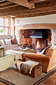 Inglenook fire place in living room of Grade II listed farmhouse living room Kent, UK