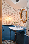 Curved panelling with Bewick Birds wallpaper in cloakroom of Grade II listed farmhouse Kent, UK
