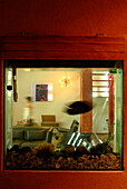 From the toilette a partial view of the fish-tank allows to catch sight of the living-room: another detail integrating the different spaces in the house