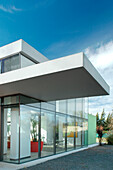Glass cube facade with extending portico