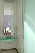 En suite bathroom with glass and mirrors