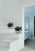 Fish sculptures on white painted staircase