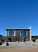 Beach house exterior with stone wall