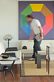 Man walks towards seating area with modern art