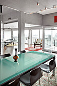 Open plan city apartment with frosted glass dining table