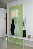 Pastel green hallway panel with square shaped light fitting
