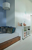 White bedroom with Moroccan furnishings and storage unit for children's toys
