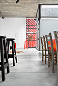 Dining chairs and stools on concrete flooring with cow hide rug