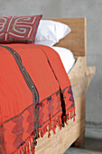 Bed made from building planks copy of Nicolas Garcia Uriburu bed with cushion from Panama and red wall-hanging from Nicaragua for bed cover