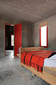 Bed made from building planks copy of Nicolas Garcia Uriburu bed with red wall-hanging from Nicaragua for bed cover