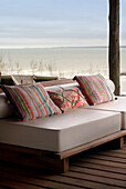 Patterned cushions on sofa on beach house veranda