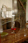 View through window to lantern on dining table