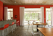 Red open plan kitchen with barstools