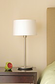 Modern table lamp and clock on night table close-up, Palermo, Buenos Aires, Argentina