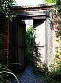 Open gates to walled garden in grounds of 1820s Grade II listed building