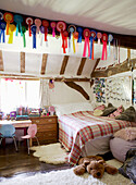 Rosettes pinned to beam of child's bedroom in 17th Century Oxfordshire home