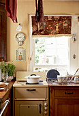 Saucepan on hob of sunlit country kitchen
