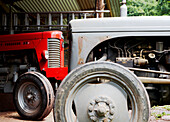 Red tractor engine in farmyard barn 
