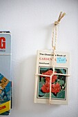 1950s style book hanging with rope on wall
