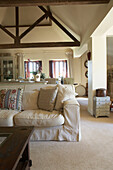 Cushions on cream sofa in beamed farmhouse conversion