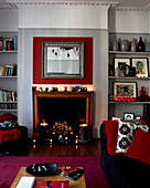Lit candles in fireplace of modern living room of Grade II listed Georgian townhouse in London
