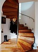 Wooden spiral staircase of new build with under stairs storage