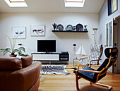 Leather sofa and chairs with plasma screen in room with skylights