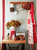 Spotted aprons and homeware on wooden side table