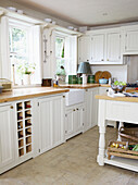 White fitted kitchen with freestanding work unit