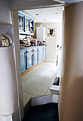 View through doorway to cottage kitchen with low ceiling