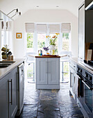 Sunlit galley kitchen with slate floor