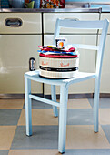1950s kitchen with pastel blue painted chair and cake tin