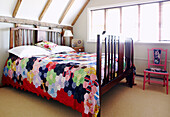 Patchwork quilt on wood varnished bed